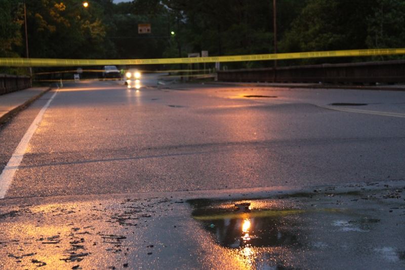 A damaged road is blocked off during the May 2010 flood.